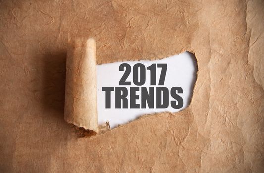 Torn piece of scroll uncovering 2017 trends underneath