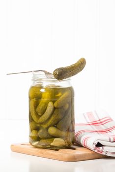 Delicious garlic dill pickle presented on a fork.