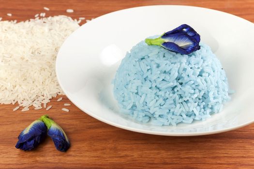 Blue Rice made cooking from Butterfly Pea flower (Clitoria ternatea L) in white dish. Rice has a colorful and fragrant flowers and good for health.