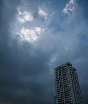 BUILDING WITH DARK STORMY SKY IN THE BACKGROUND