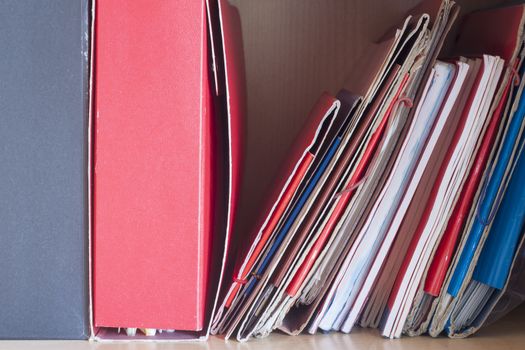 Stacks of colored folders with documents on the desktop