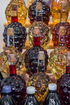 set of bottle in the form of grapes are filled with wine