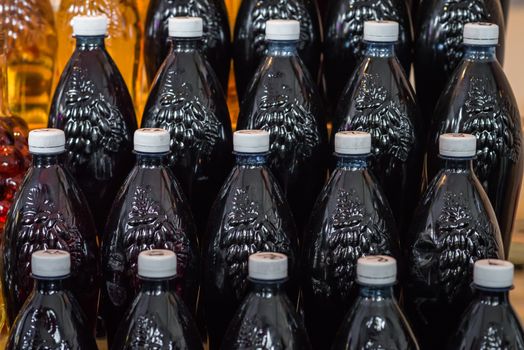 set of plastic bottles filled with red wine