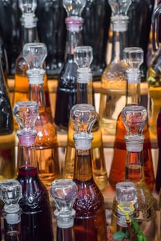 set of glass bottles filled with red and white wine