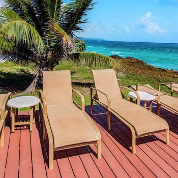 Loungers on the deck by the seafront Tobago Caribbean square composition