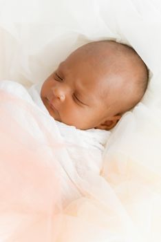 Three weeks old baby sleeping on white blanket cute infant newborn lying down close up shot eyes closed