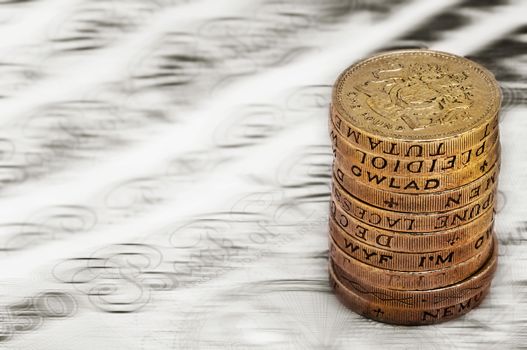 Sterling pound depreciation devaluation reduction value concept closeup macro view at UK currency stack of one pound coins