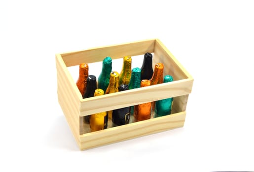 Wooden box of twelve bottles of chocolate filled with liqueur on a white background