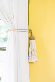 White curtain tie-back home decor simple style indoors yellow wall