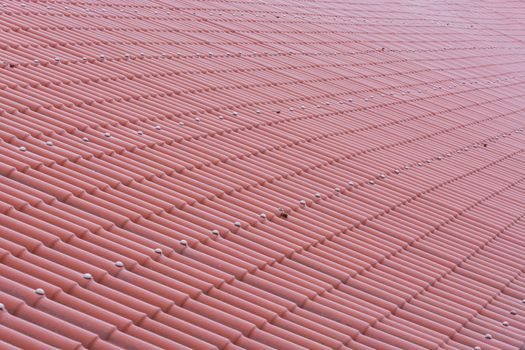 Close up of a roof with red tiles.