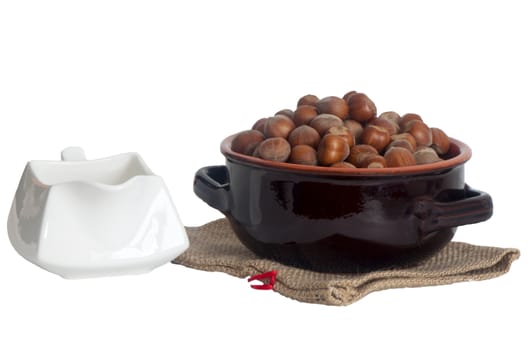 some hazelnuts placed over a white background