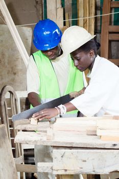 next to her teacher and assistant her , the young student saw the wood with the saw.