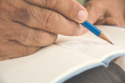 man writing a tree on sketchbook,Environment Conservative concept