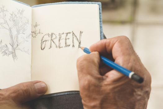 man writing a tree on sketchbook,Environment Conservative concept