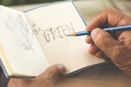 man writing a tree on sketchbook,Environment Conservative concept