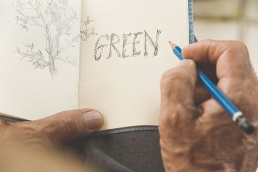 man writing a tree on sketchbook,Environment Conservative concept