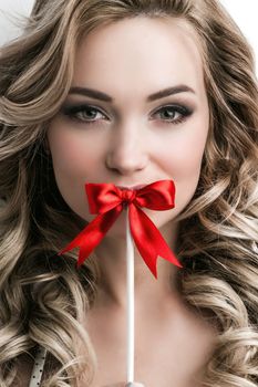 Portrait of young beautiful girl with a bow on a stick