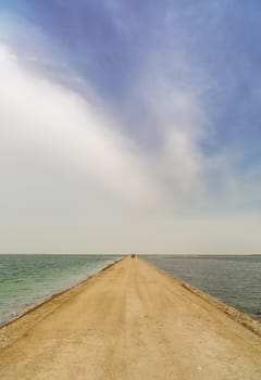 road from sand through the dead sea