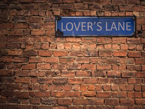 Lover's Lane Sign On A Grungy Old Red Brick Wall