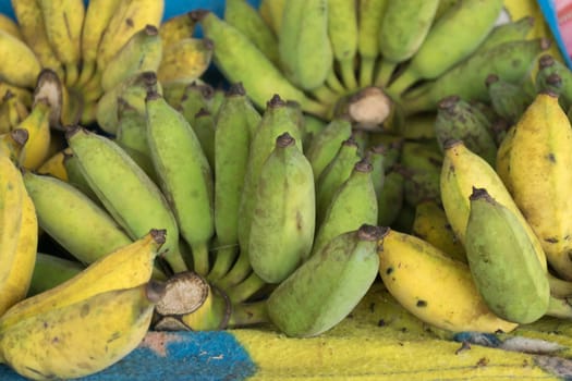 Green and yellow bananas on the market, Thailand.