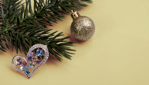 brooch with multi-colored crystals on a branch tree . New Year's still-life