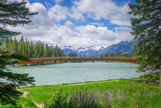 Bow River running around and through Banff with Bridge