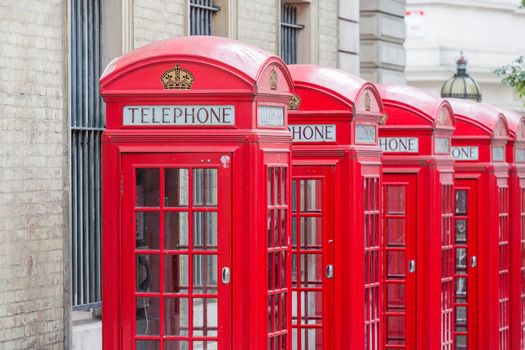 Five Red London Telephone boxes all in a row in the City