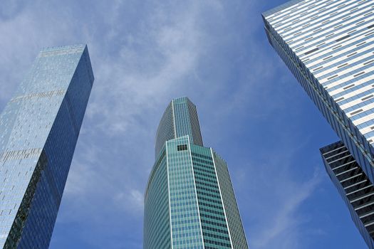 Modern buildings of glass and steel skyscrapers against the sky.