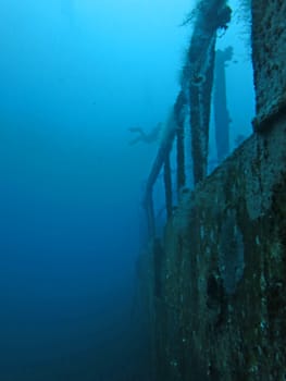 massive shipwreck, sits on a sandy seafloor in bali