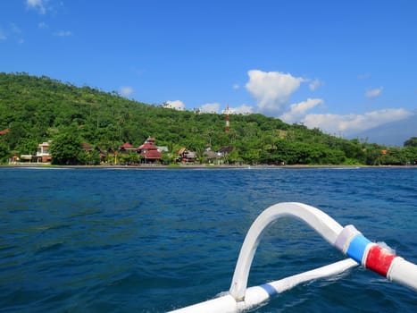 View from boat, lagoon and green coast village. Bali, Indonesia