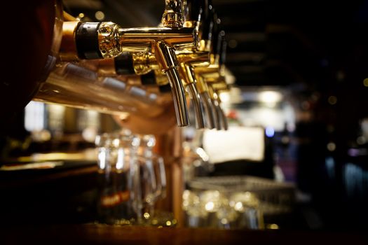 golden shiny beer taps in beer bar