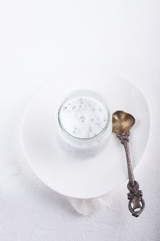Yogurt with chia seeds on a white background