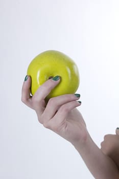 Green apple in hand on white background