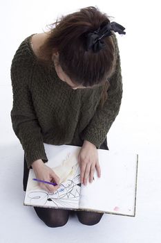 Young girl artist drawing pencils on white background