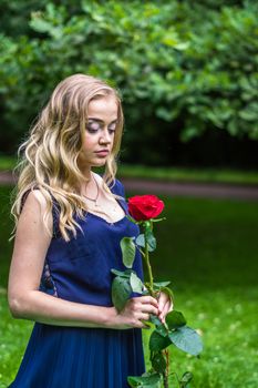 beautiful girl with a red rose in the Park
