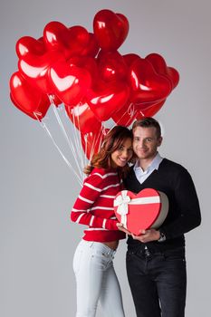 Couple with heart shaped balloons and gifts, Valentines day