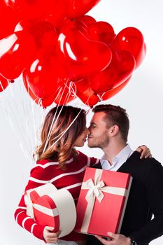 Couple with heart shaped balloons and gifts, Valentines day
