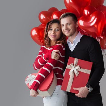 Couple with heart shaped balloons and gifts, Valentines day