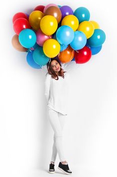 Happy woman with many colorful balloons