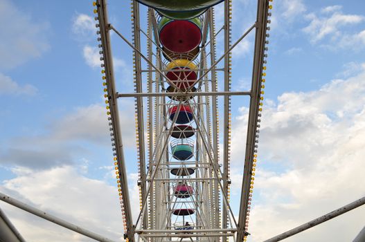 the swing cable basket ferris wheel on blue sky cloud background at amusement park is the family vacation activity on holiday