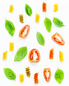 Italian food concept Fusilli with tomato and sweet basil isolate on white background. Fusilli and ingredients with flat lay.