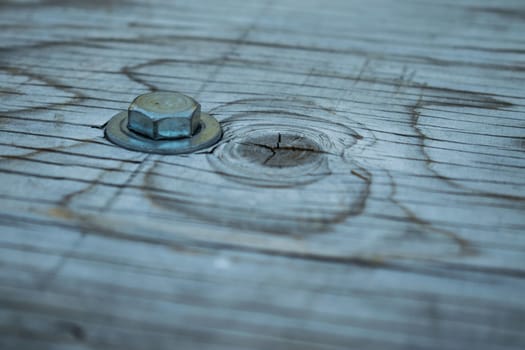 A close up of a bolt in the wood