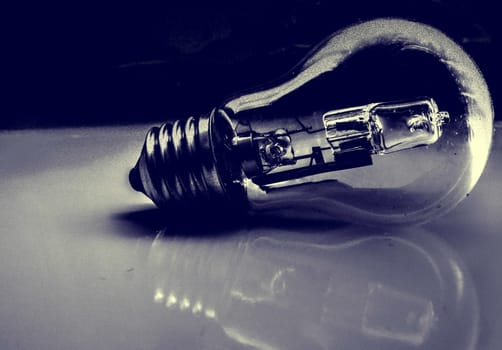 A light bulb with reflection black and white background