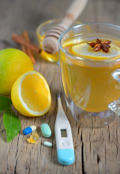 Thermometer and cup of tea, pills,tea