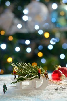 Christmas tree and sleigh decoration with figurines on fake snow