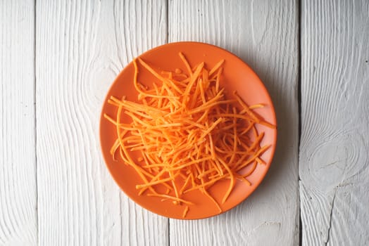 Fresh grated carrot on a plate horizontal