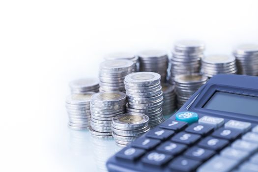 counting income, pile of money, calculator in white background