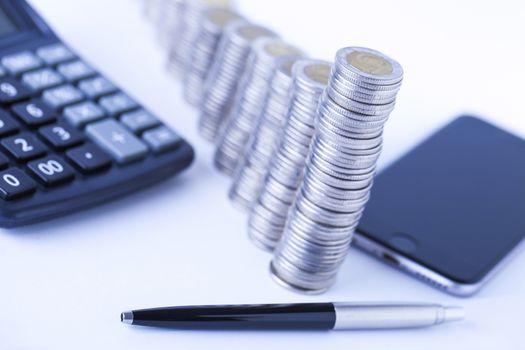 counting income, pile of money, calculator in white background