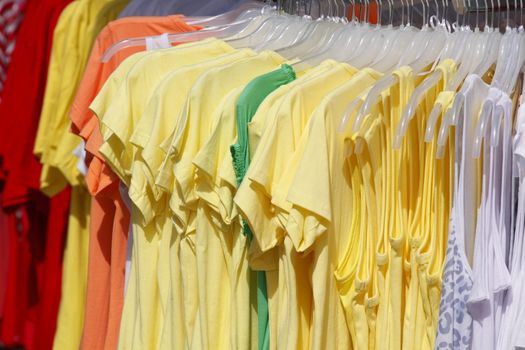 Colorful shirts on a clothes rail