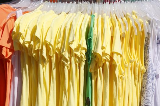 Colorful shirts on a clothes rail